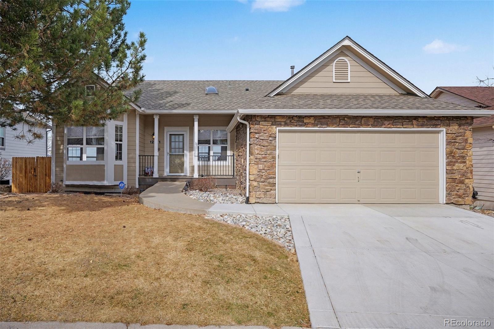 12271 West Chenango Drive Morrison, CO 80465 - Photo 30 of 37 a front view of a house with a yard and garage