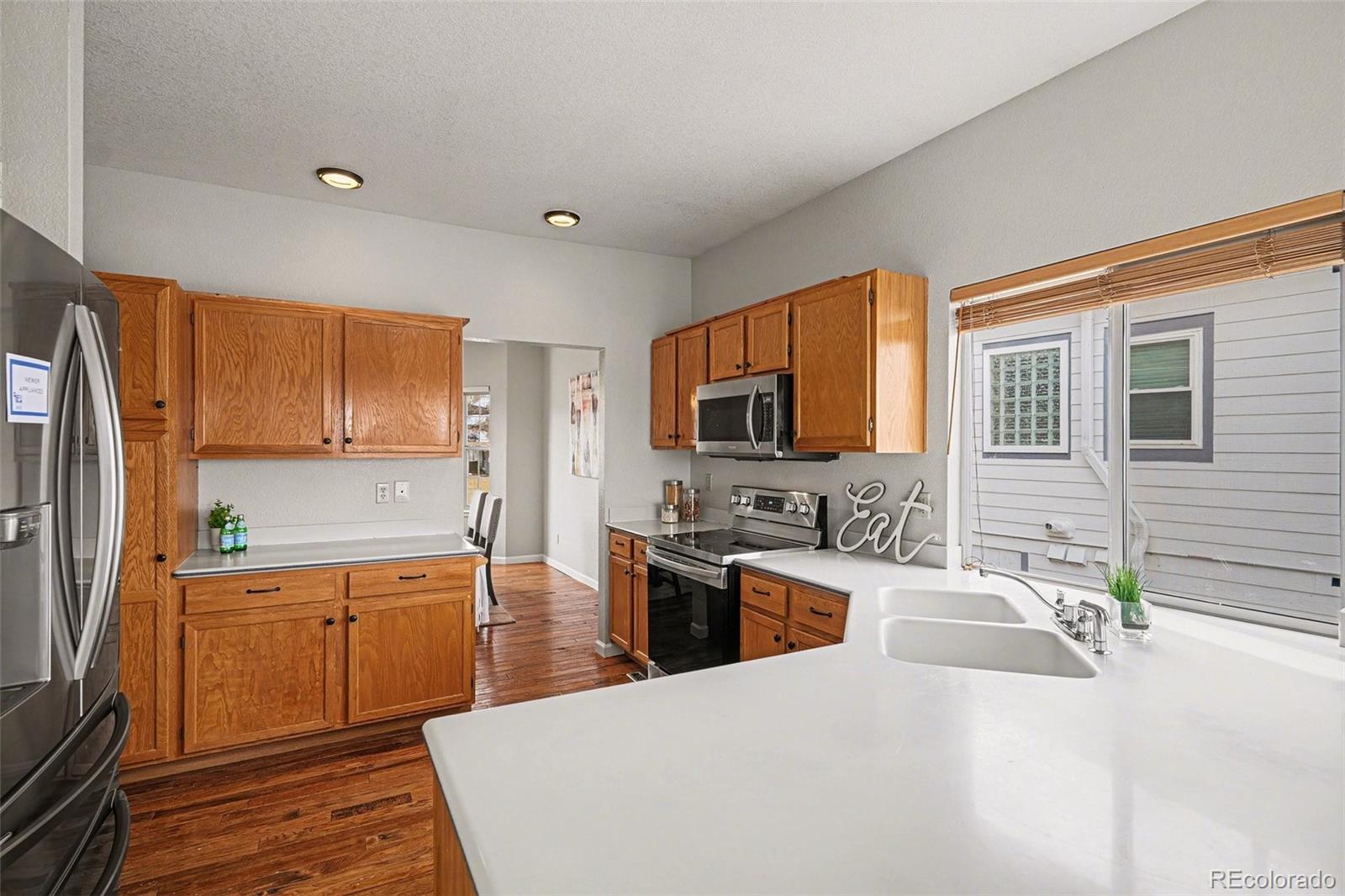 12271 West Chenango Drive Morrison, CO 80465 - Photo 6 of 37 a large kitchen with a large window in it and stainless steel appliances