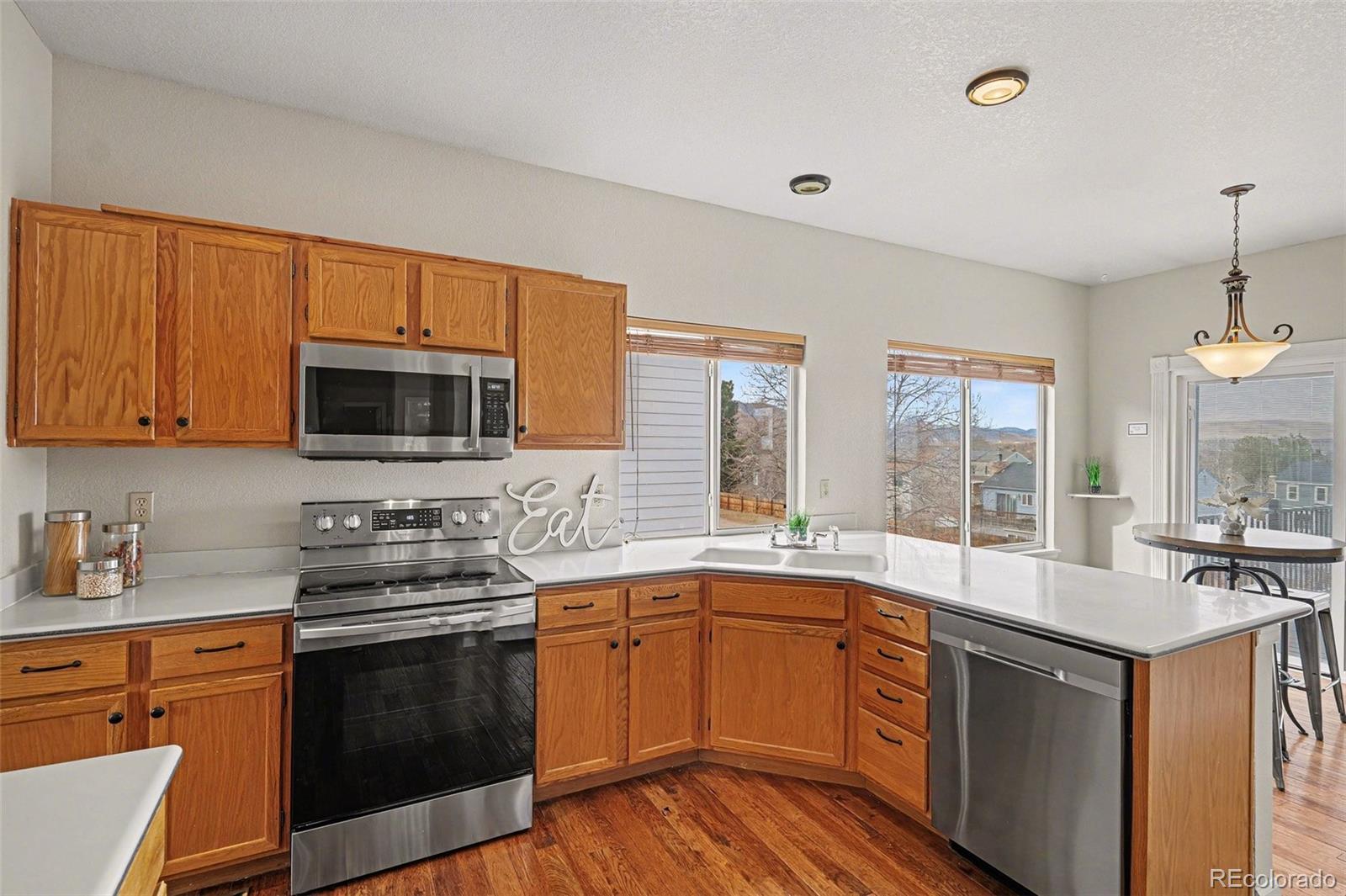 12271 West Chenango Drive Morrison, CO 80465 - Photo 8 of 37 a kitchen with a sink stove and microwave