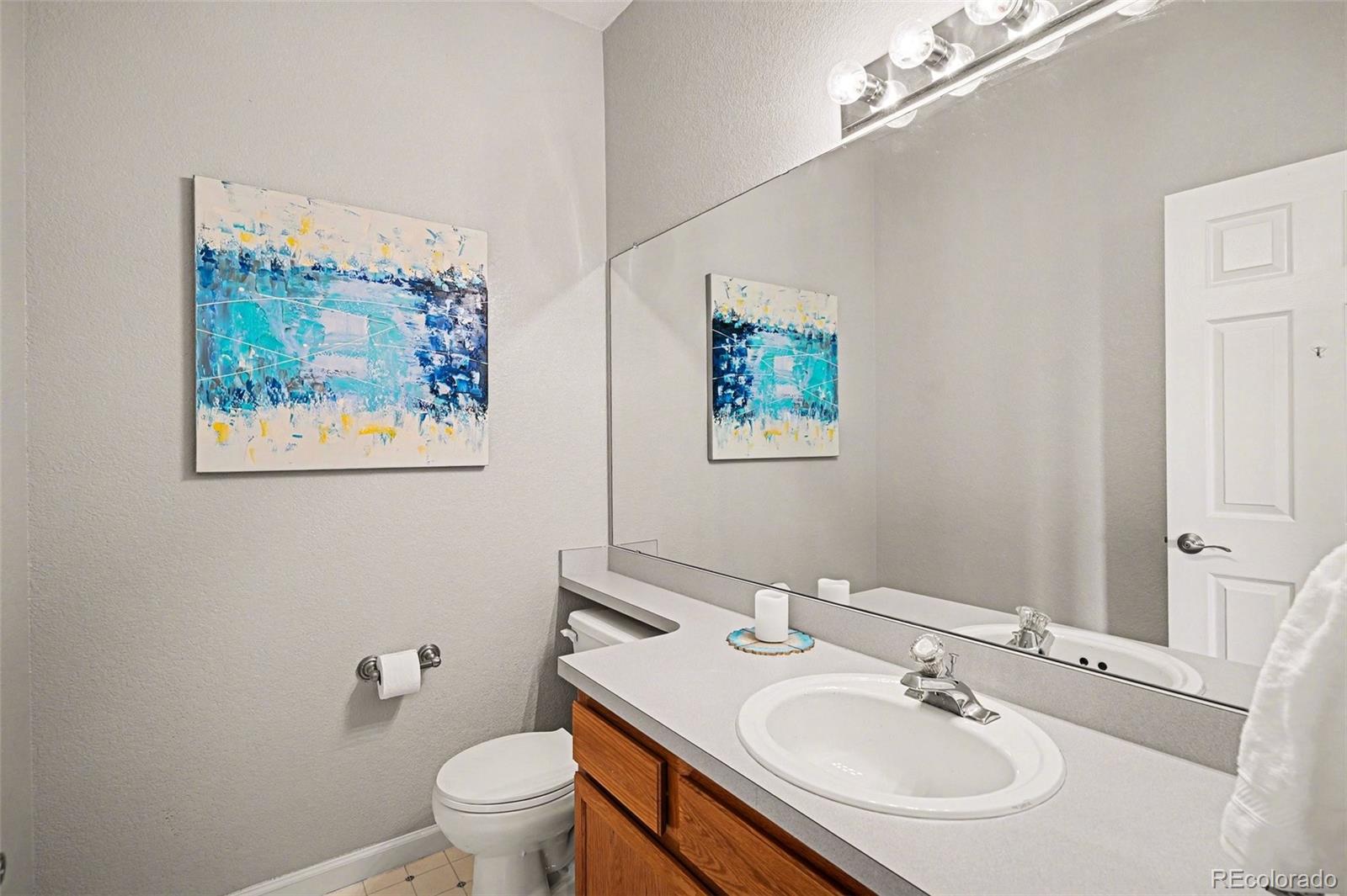 12271 West Chenango Drive Morrison, CO 80465 - Photo 10 of 37 a bathroom with a sink toilet and a mirror
