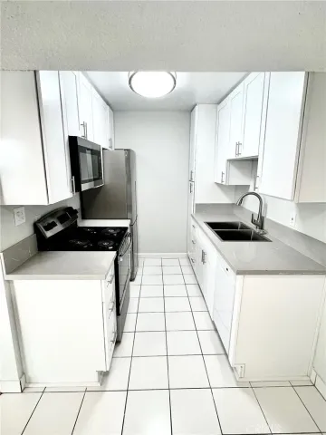 a kitchen with a sink and a stove top oven
