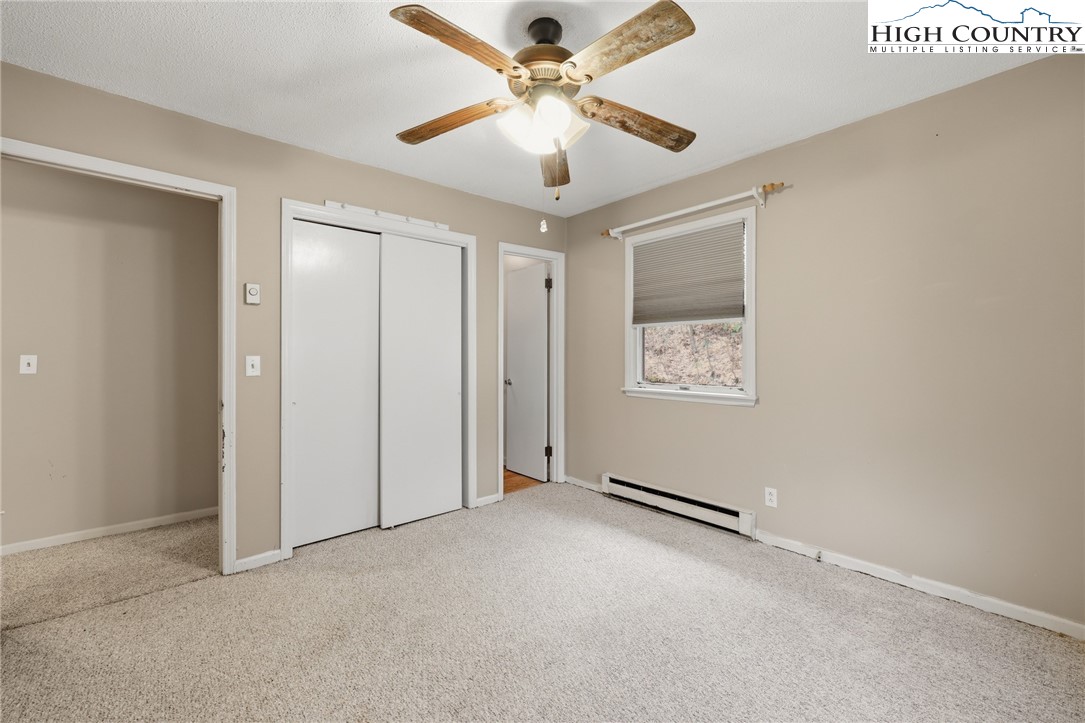 2202 Old 16 Highway Jefferson, NC 28640 - Photo 11 of 15 an empty room with windows and fan