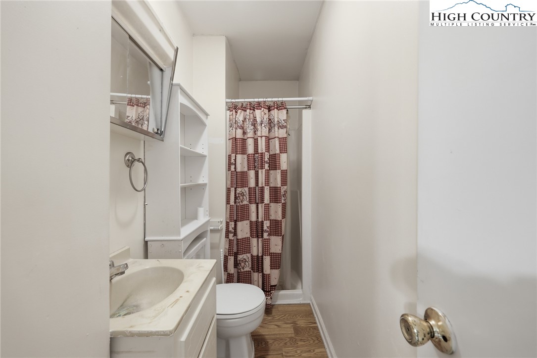 2202 Old 16 Highway Jefferson, NC 28640 - Photo 12 of 15 a bathroom with a granite countertop toilet and a shower