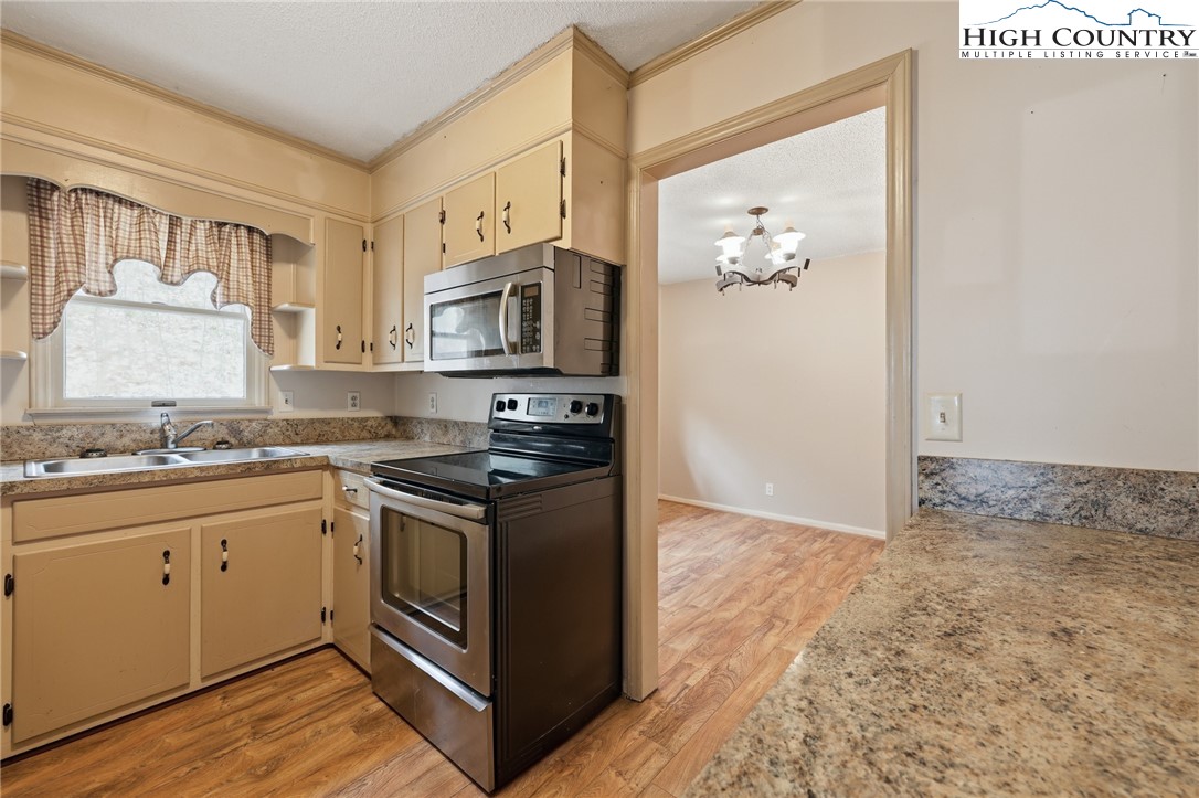 2202 Old 16 Highway Jefferson, NC 28640 - Photo 2 of 15 a kitchen with stainless steel appliances granite countertop a stove and a sink