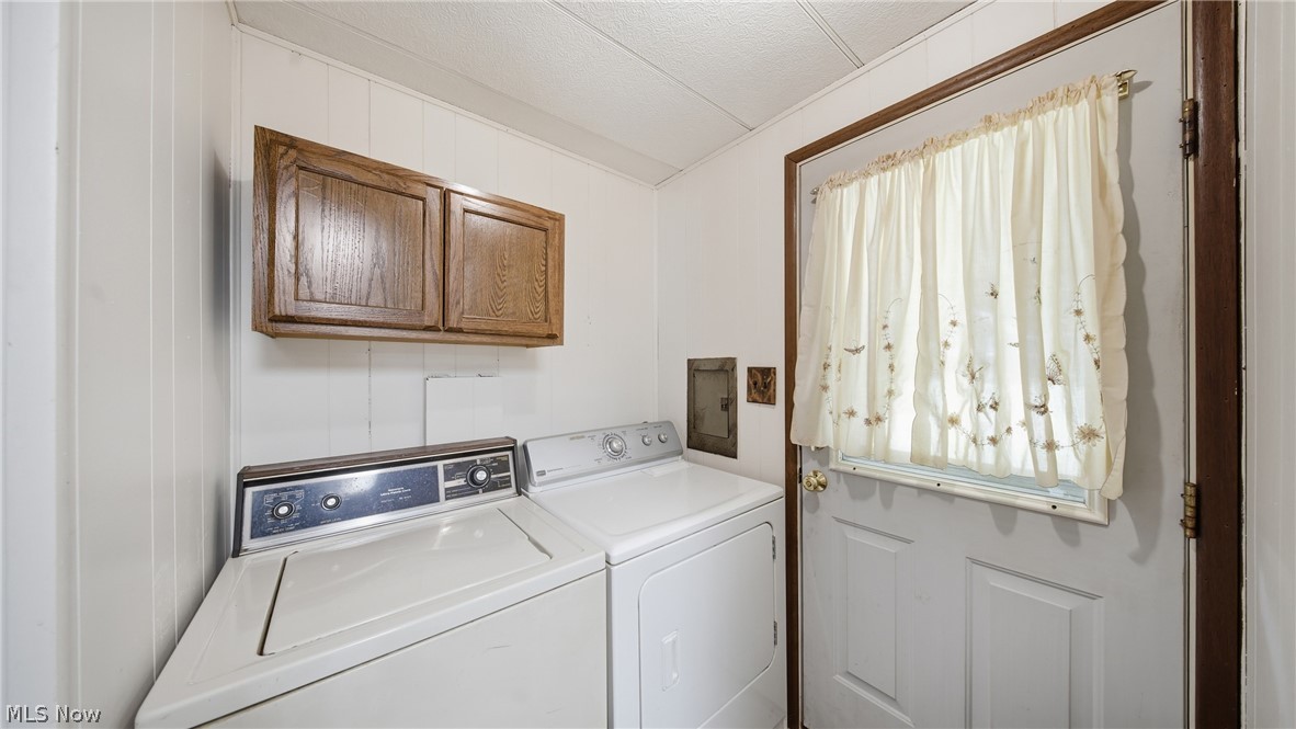 337 Wadesville Road Washington, WV 26181 - Photo 24 of 36 Laundry area featuring wood-paneled walls and a ceiling-mounted light fixture