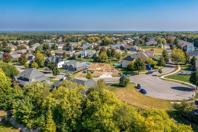 an aerial view of a house with a swimming pool yard and outdoor seating