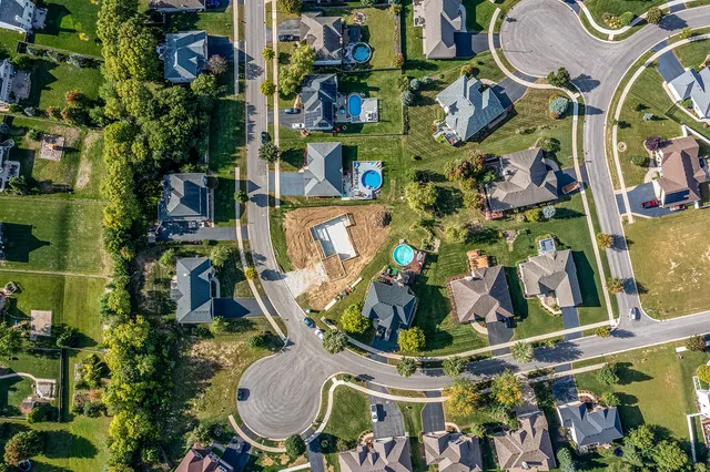 an aerial view of a house with yard swimming pool and outdoor seating