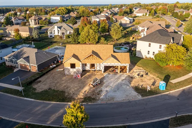 an aerial view of a house with a swimming pool