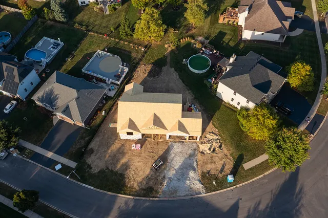 an aerial view of a house with a swimming pool