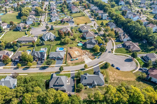 an aerial view of residential houses with outdoor space