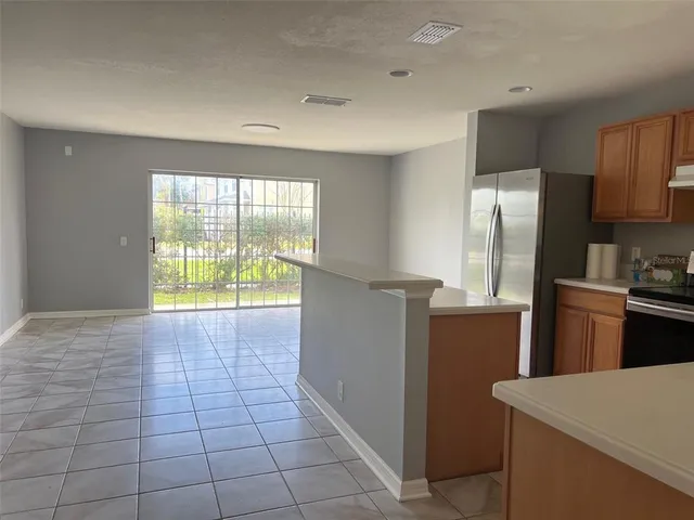 a kitchen that has a sink and a refrigerator
