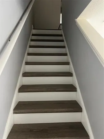 a view of a room with wooden floor and windows in it