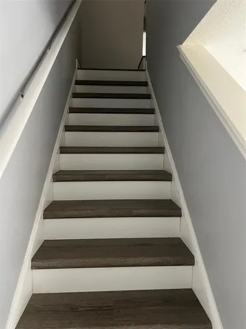 a view of a room with wooden floor and windows in it