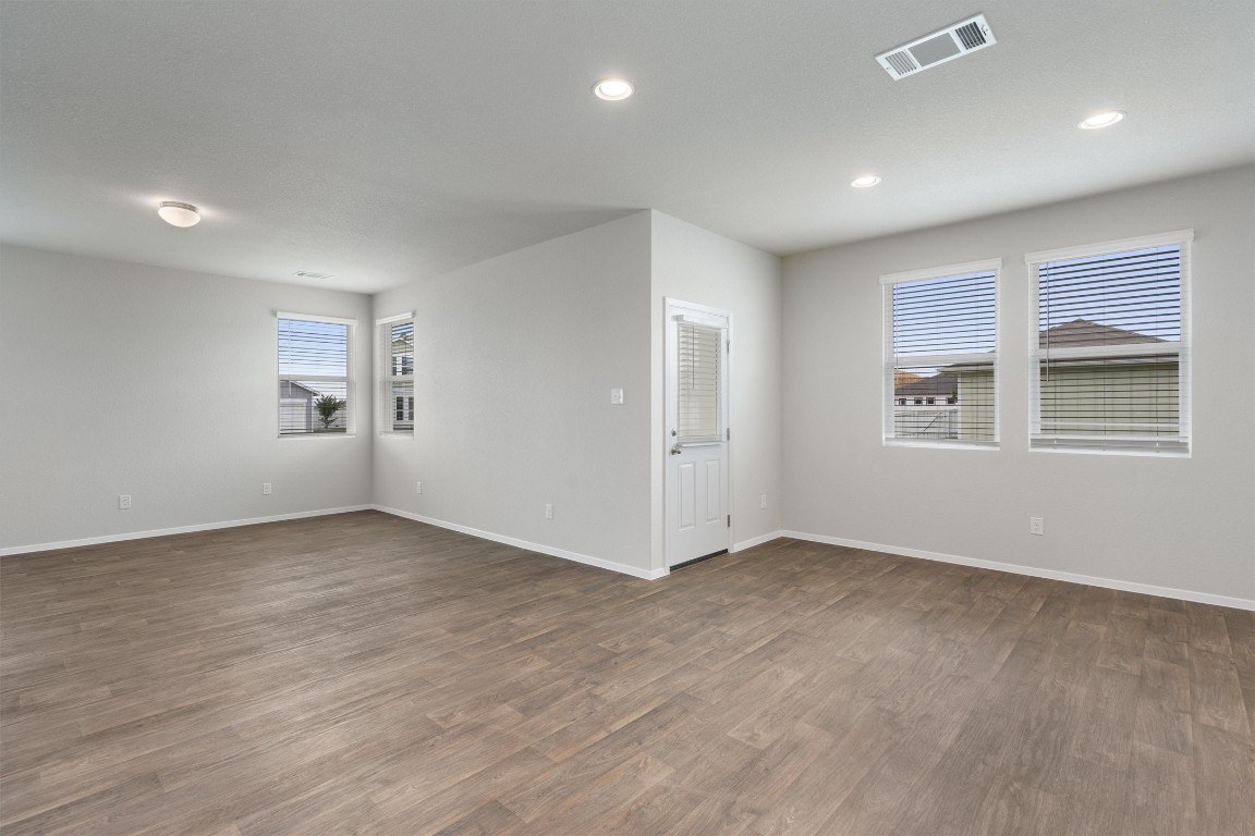 101 Keltic Drive Kyle, TX 78640 - Photo 11 of 29 wooden floor in an empty room with a window