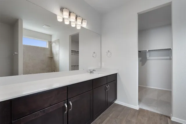 a bathroom with a double vanity sink and a mirror