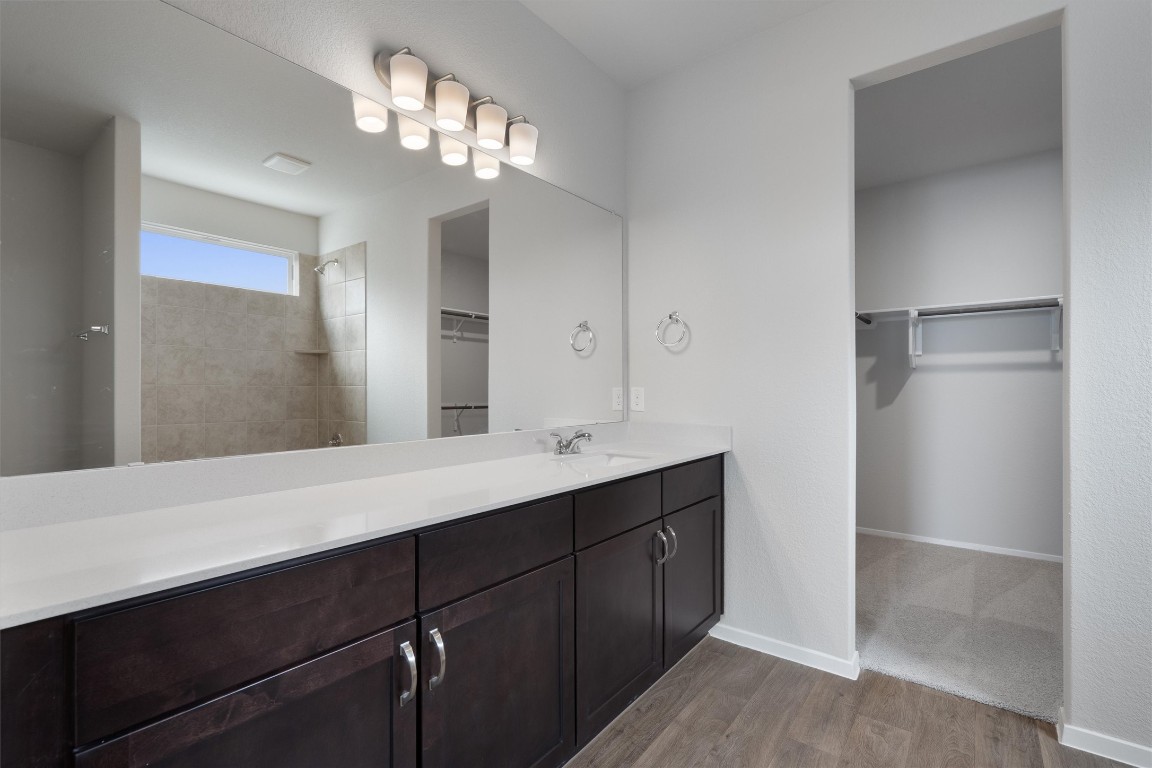 101 Keltic Drive Kyle, TX 78640 - Photo 14 of 29 a bathroom with a double vanity sink and a mirror