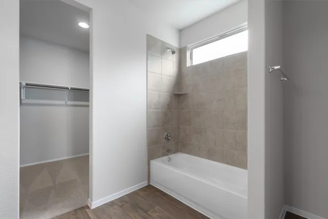 a bathroom with a bathtub and a shower