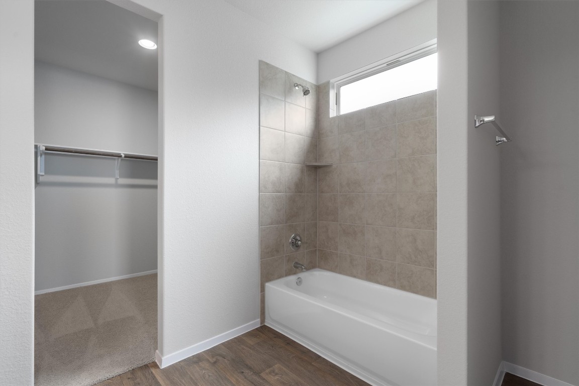 101 Keltic Drive Kyle, TX 78640 - Photo 15 of 29 a bathroom with a bathtub and a shower