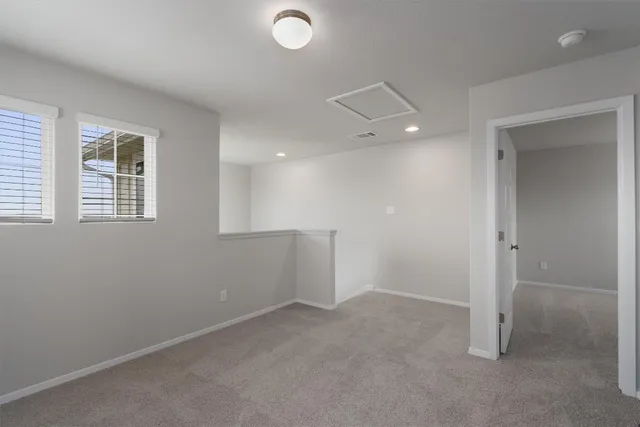 an empty room with windows and closet