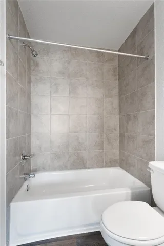 a bathroom with a bathtub toilet and shower