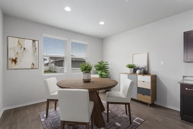 a dining room with furniture and window