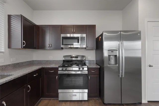 a kitchen with a refrigerator stove and microwave