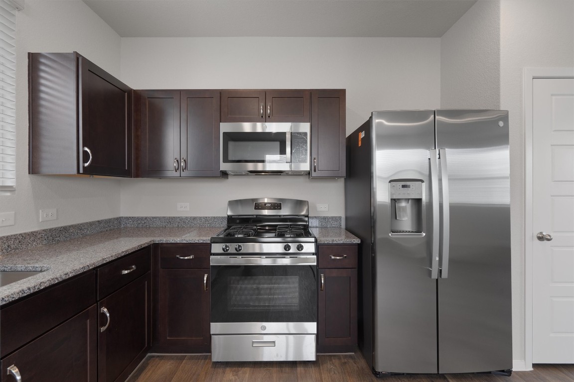 101 Keltic Drive Kyle, TX 78640 - Photo 10 of 29 a kitchen with a refrigerator stove and microwave
