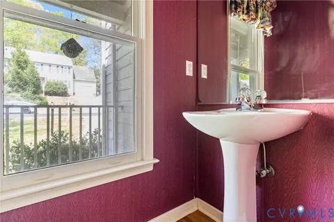 a bathroom with a sink a mirror and a window