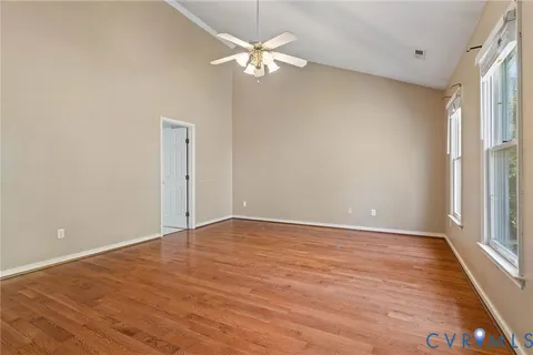 wooden floor in an empty room with a window