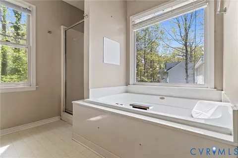a bath tub sitting in a bathroom next to a window