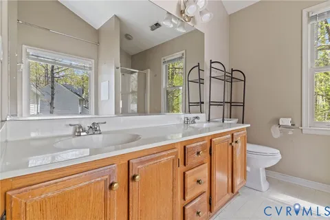 a bathroom with a granite countertop sink mirror and a bathtub