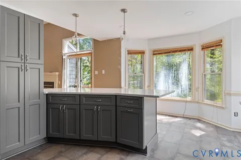 a open kitchen with granite countertop a refrigerator and a sink