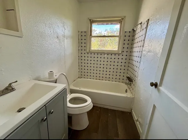a bathroom with a sink a toilet and a bathtub