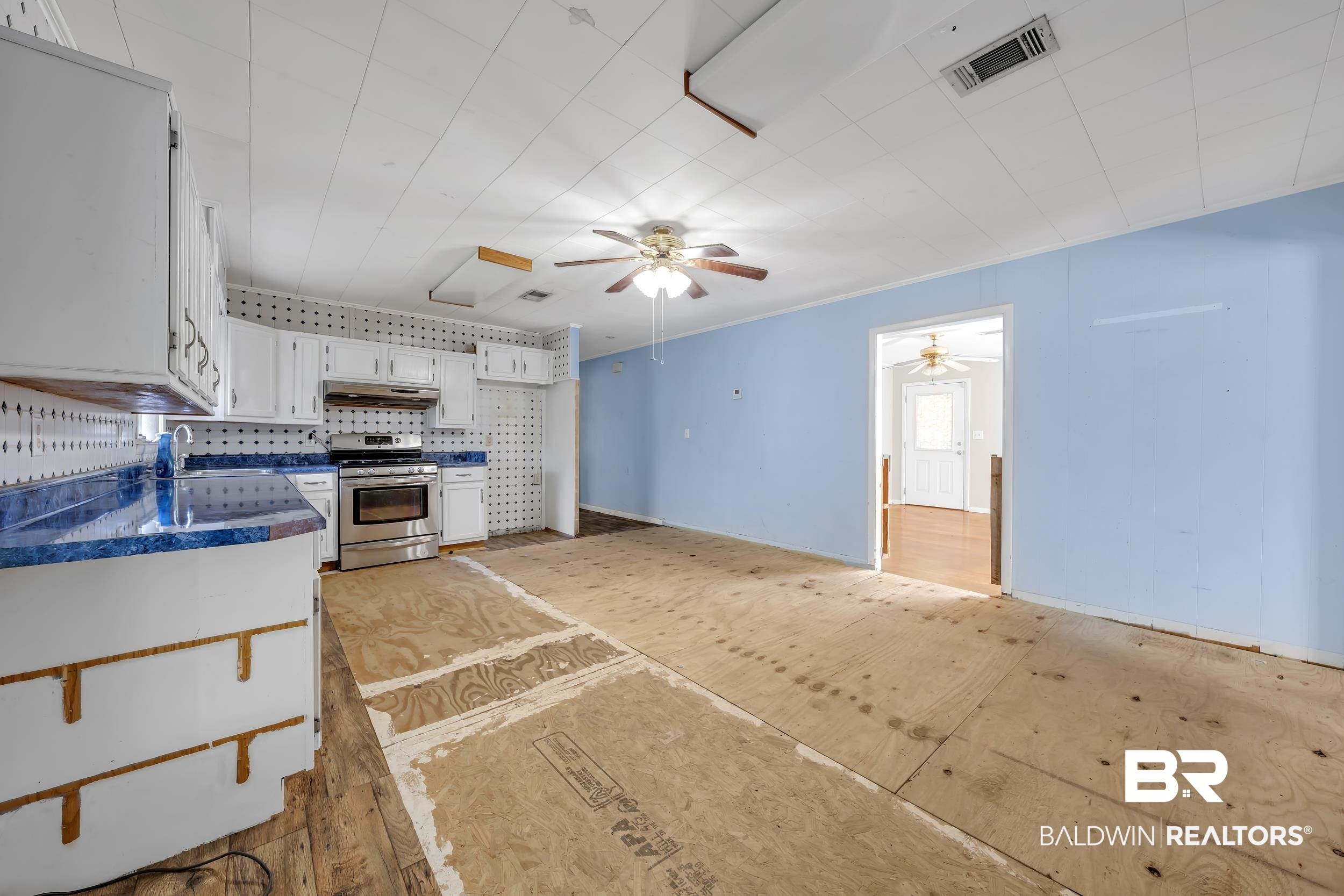 17463 Highway 98 Foley, AL 36535 - Photo 7 of 57 Kitchen with white cabinets, dark countertops, stainless steel range with gas cooktop, decorative backsplash, and ceiling fan