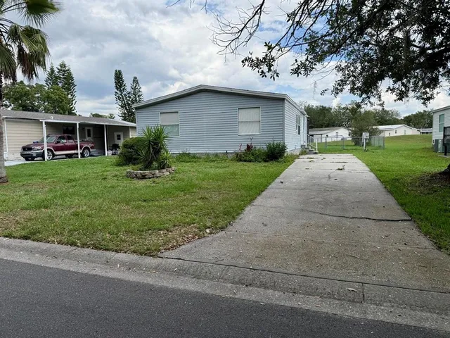 a front view of house with yard and trees