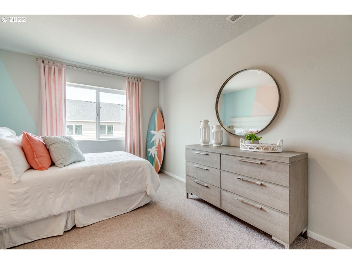 2699 26th Loop Springfield, OR 97477 - Photo 11 of 13 a bedroom with a bed and a dresser