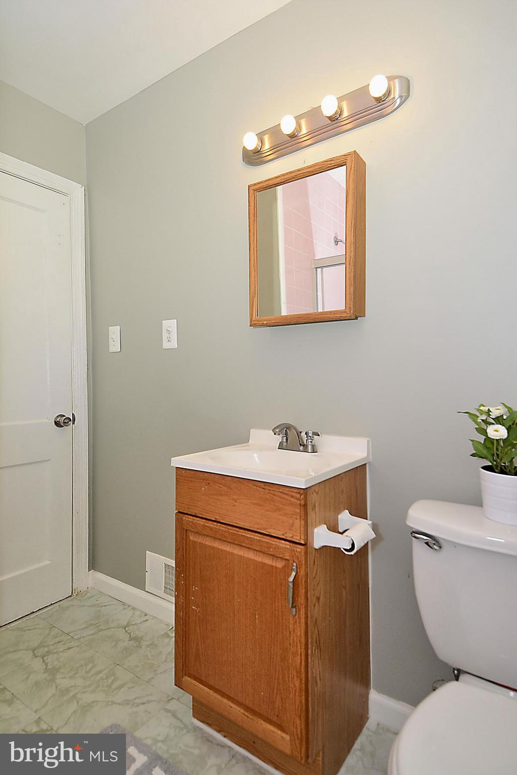 2709 Newton Street Silver Spring, MD 20902 - Photo 13 of 25 a bathroom with a toilet sink and mirror