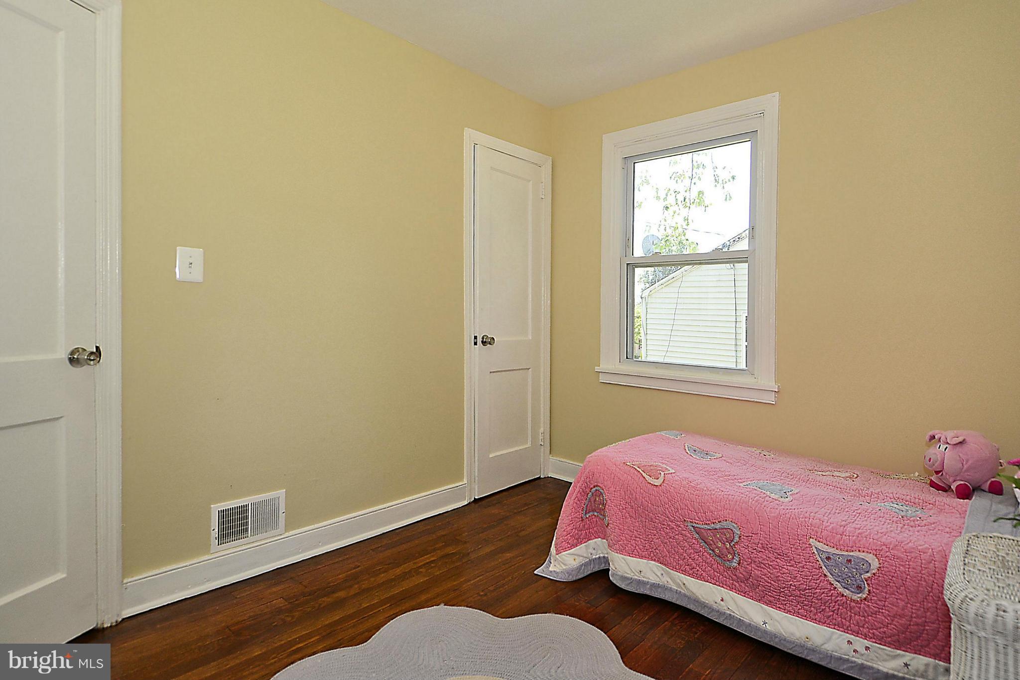 2709 Newton Street Silver Spring, MD 20902 - Photo 17 of 25 a bedroom with a bed and wooden floor