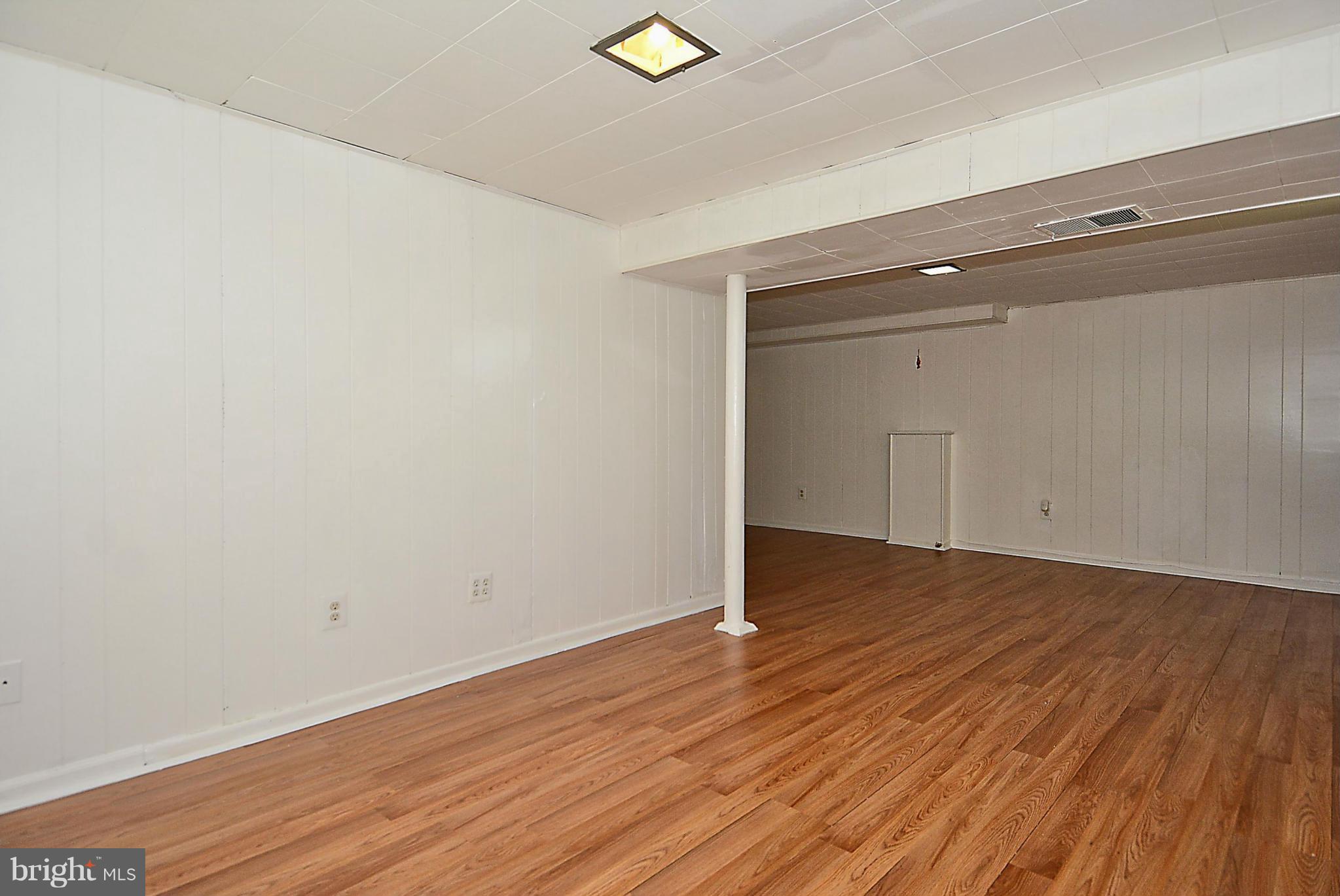 2709 Newton Street Silver Spring, MD 20902 - Photo 24 of 25 a view of an empty room with wooden floor and a window