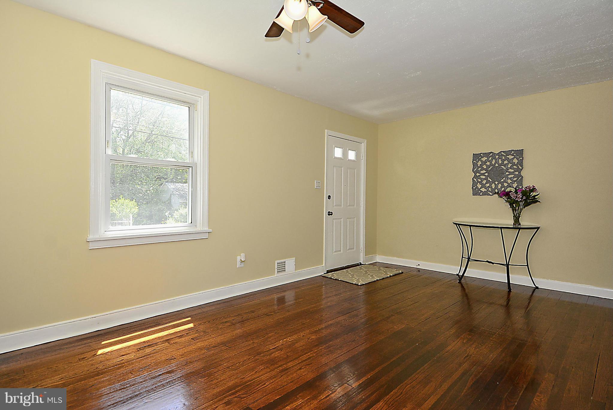 2709 Newton Street Silver Spring, MD 20902 - Photo 7 of 25 a view of an empty room with wooden floor and a window