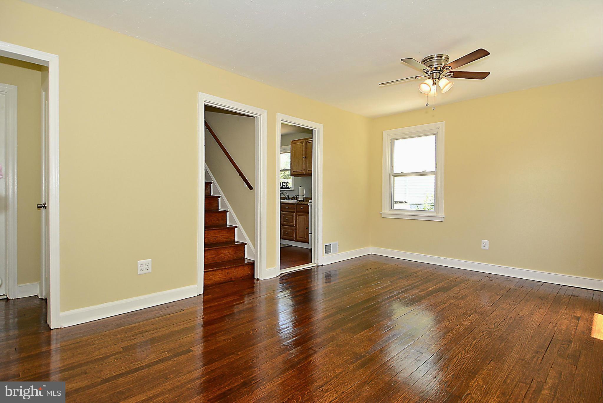 2709 Newton Street Silver Spring, MD 20902 - Photo 8 of 25 a view of an empty room with a window and wooden floor