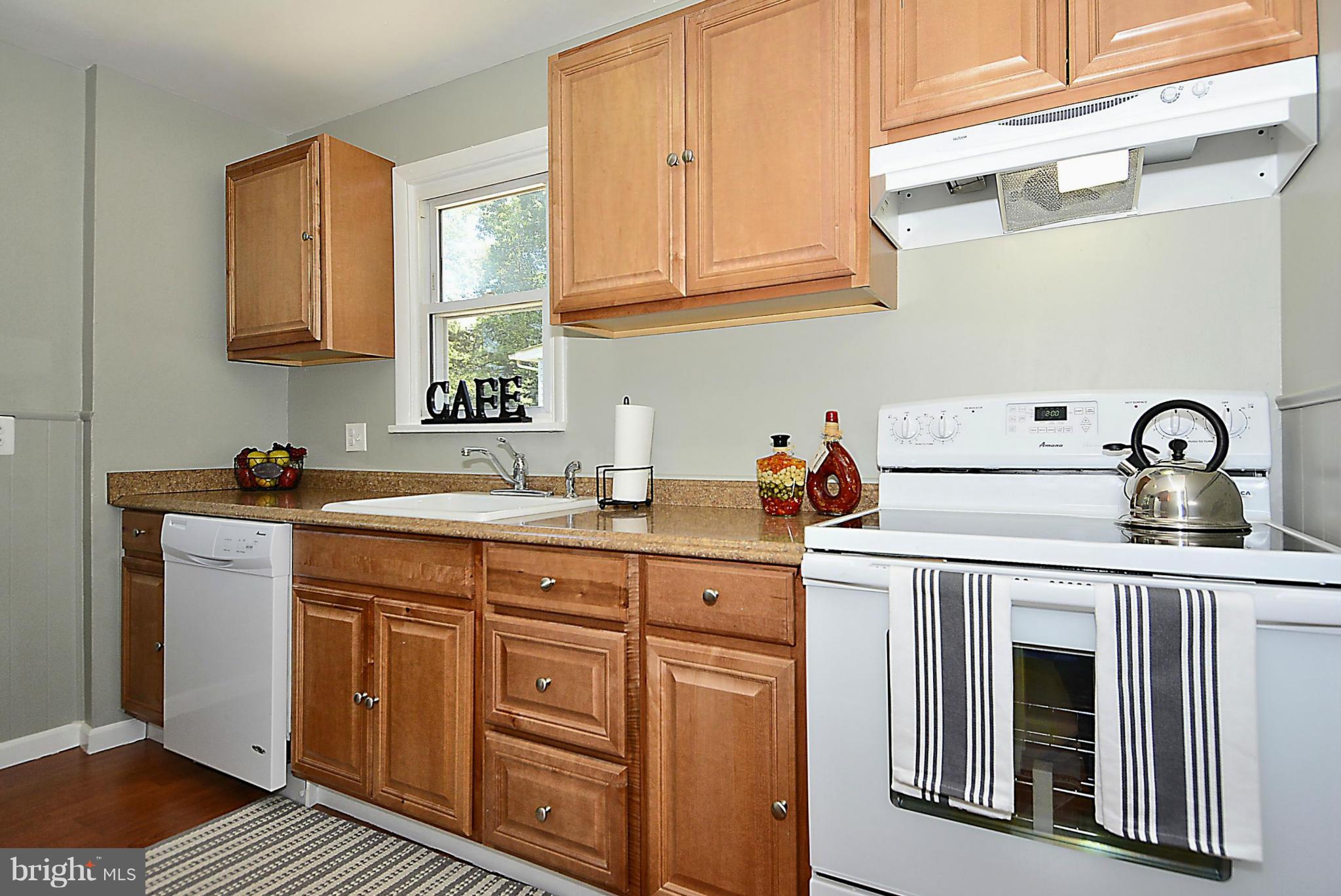 2709 Newton Street Silver Spring, MD 20902 - Photo 10 of 25 a kitchen with stainless steel appliances granite countertop a sink dishwasher a stove and cabinets with wooden floor