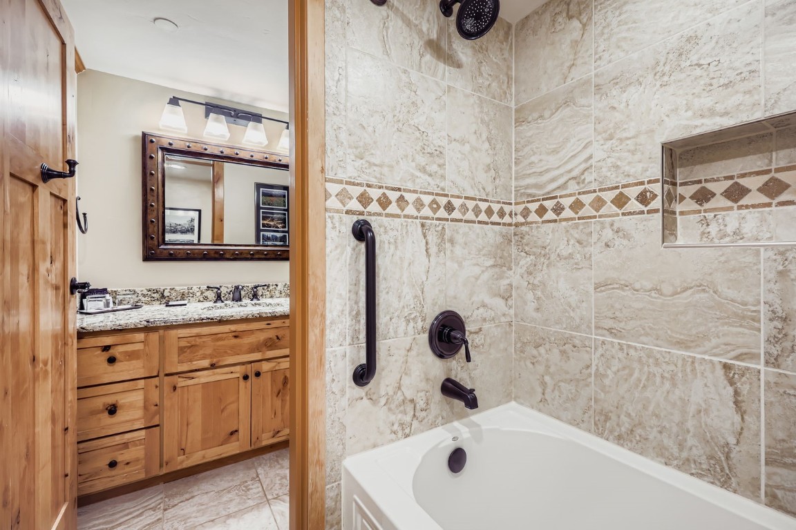 640 Village Road, Unit 4320 Breckenridge, CO 80424 - Photo 11 of 39 a bathroom with a tub sink and mirror