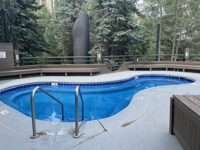 640 Village Road, Unit 4320 Breckenridge, CO 80424 - Photo 12 of 39 a view of a swimming pool with a bench and trees