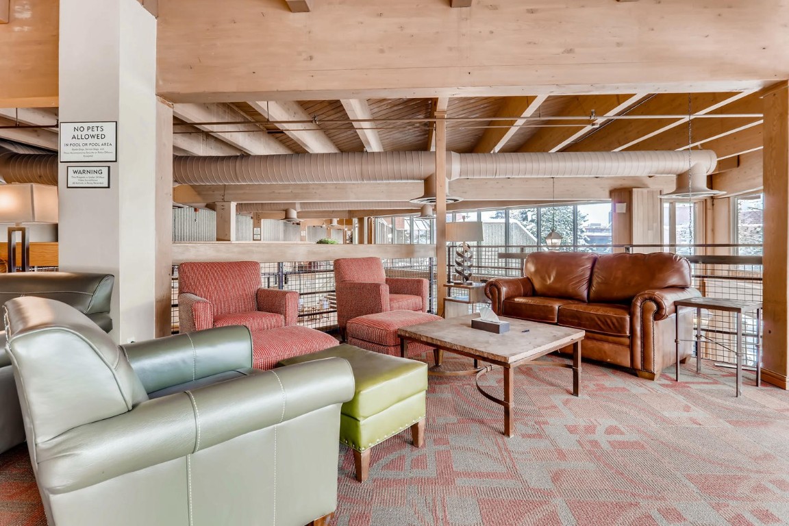640 Village Road, Unit 4320 Breckenridge, CO 80424 - Photo 16 of 39 a living room with furniture a flat screen tv and a table