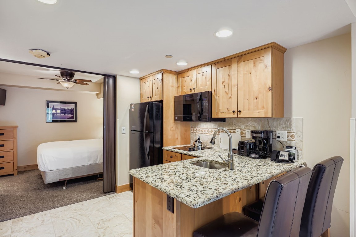 640 Village Road, Unit 4320 Breckenridge, CO 80424 - Photo 5 of 39 a kitchen with stainless steel appliances granite countertop a sink refrigerator and microwave