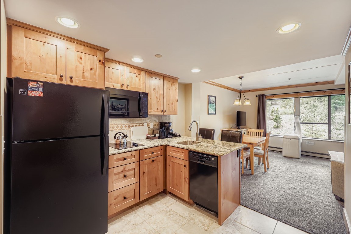 640 Village Road, Unit 4320 Breckenridge, CO 80424 - Photo 6 of 39 a kitchen with a sink a refrigerator a stove and cabinets