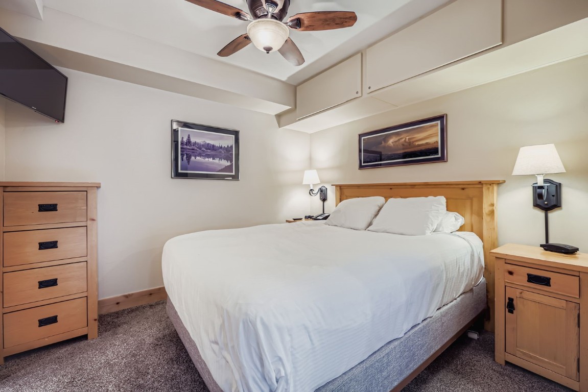 640 Village Road, Unit 4320 Breckenridge, CO 80424 - Photo 9 of 39 a bedroom with a bed and a lamp on a dresser