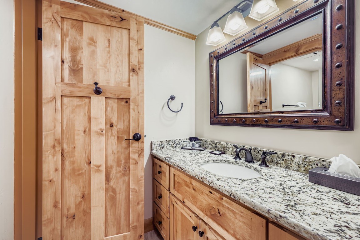 640 Village Road, Unit 4320 Breckenridge, CO 80424 - Photo 10 of 39 a bathroom with a granite countertop sink and a mirror