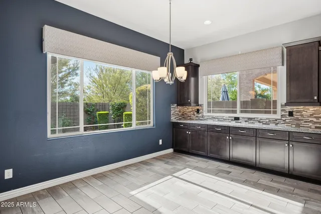 a large kitchen with kitchen island granite countertop a large window in it